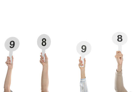 Panel of judges holding different score signs on white background, closeupの写真素材