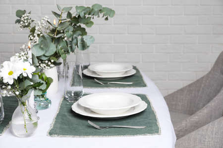 Elegant festive setting with floral decor on tableの写真素材