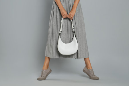 Woman with stylish bag on gray background, closeupの写真素材