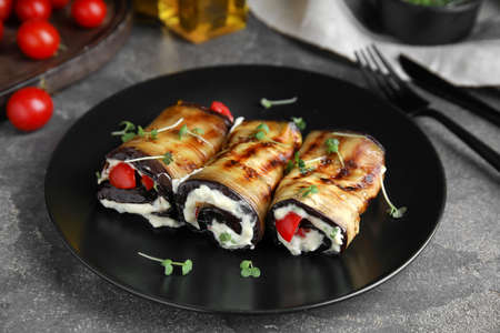 Delicious baked eggplant rolls served on gray tableの写真素材