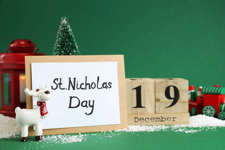 19 December Saint Nicholas Day. Block calendar, card and festive decor on green backgroundの写真素材