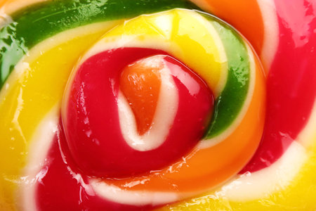 Sweet colorful lollipop on pink background, closeup view. Delicious candyの写真素材