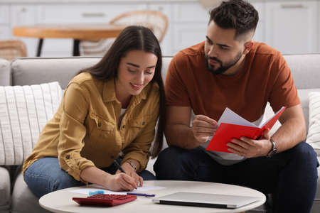 Young couple discussing family budget at homeの写真素材