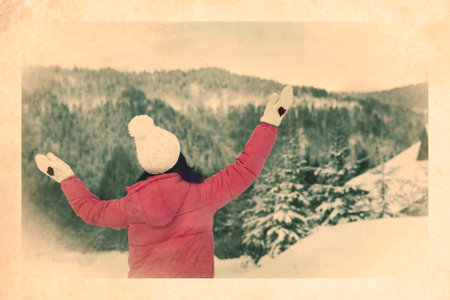Old paper photo. Woman enjoying trip on snowy day, back viewの写真素材