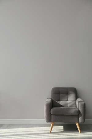 Stylish armchair near gray wall, space for text. Interior elementの写真素材