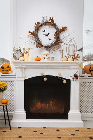Modern room with fireplace decorated for Halloween. Festive interiorの写真素材