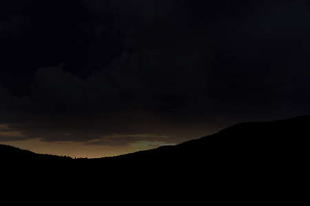 Beautiful view of starry sky over mountains at nightの写真素材