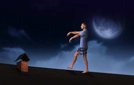 Sleepwalker wearing pajamas on roof in nightの写真素材