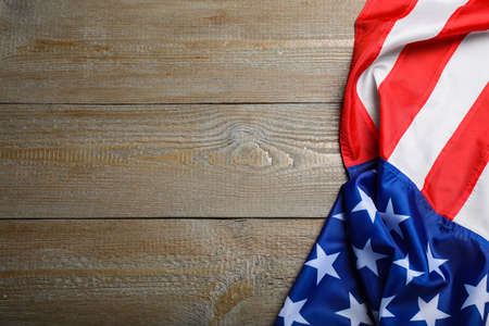 American flag on wooden table, top view. Space for textの写真素材