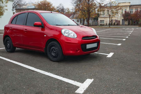 Modern red car on parking lot outdoors