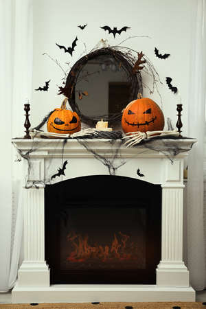 Different Halloween decor on mantelpiece indoors. Festive interiorの写真素材