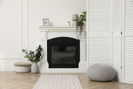 Stylish room with folding screen and fireplace. Interior designの写真素材