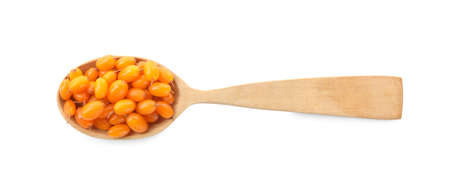 Fresh ripe sea buckthorn berries in wooden spoon on white background, top viewの写真素材