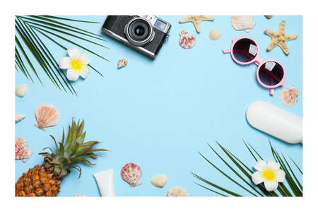 Paper photo. Flat lay composition with beach accessories on light blue backgroundの写真素材