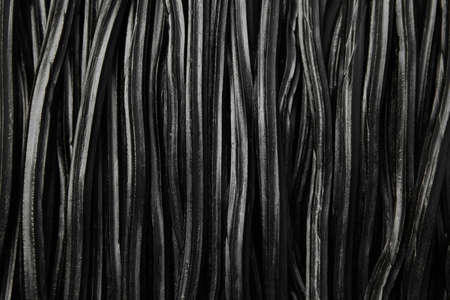 Tasty black liquorice candies as background, top viewの写真素材