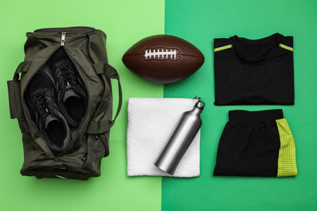 Gym bag and sports equipment on green background, flat layの写真素材