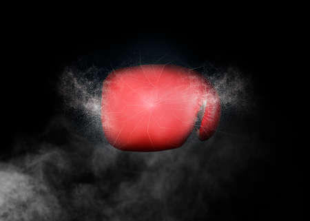 Red boxing glove and smoke on black backgroundの写真素材