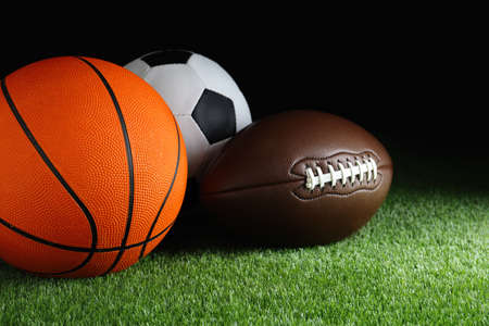 Set of different sport balls on green grassの写真素材