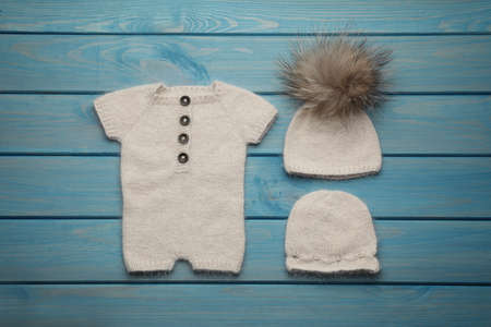Set of cute baby knitwear for photoshoot on light blue wooden background, flat layの写真素材