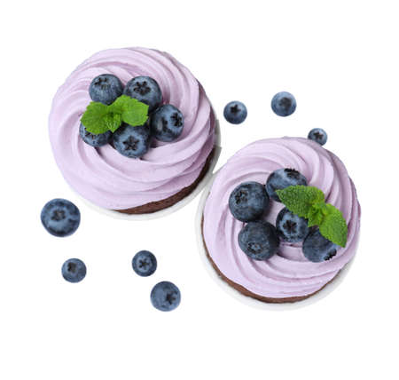 Sweet cupcakes with fresh blueberries on white background, top viewの写真素材