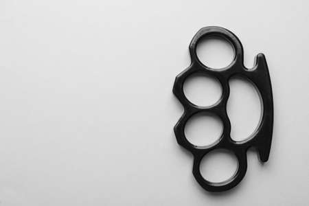 Black brass knuckles on white background, top view. Space for textの写真素材
