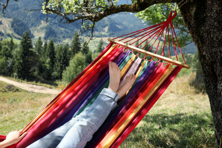Woman resting in hammock outdoors on sunny day, closeupの写真素材