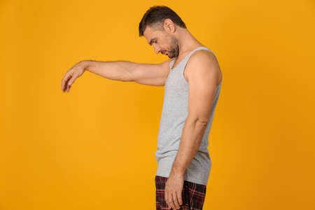 Man in sleepwalking state on yellow background