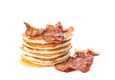 Delicious pancakes with maple syrup and fried bacon on white backgroundの写真素材