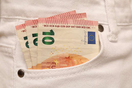 Euro banknotes in pocket of white jeans, closeup. Spending moneyの写真素材