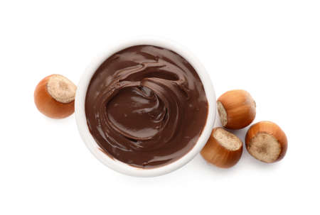 Bowl of chocolate paste with hazelnuts on white background, top viewの写真素材