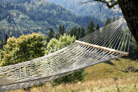 Empty comfortable net hammock in mountains on sunny dayの写真素材
