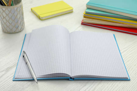 Open notebook and pen on white wooden table. Personal planningの写真素材