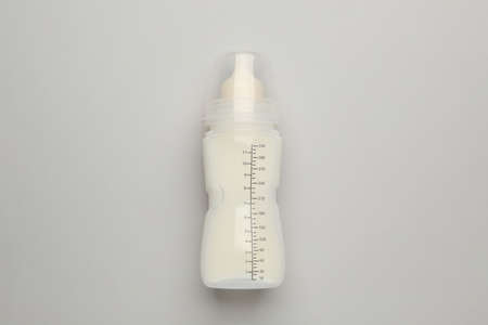 Feeding bottle with infant formula on light background, top viewの写真素材