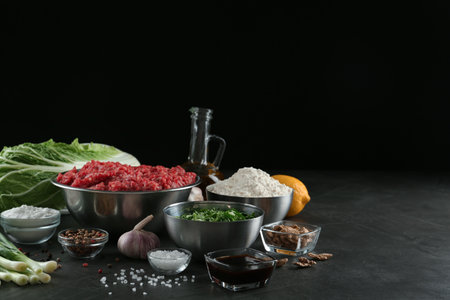 Composition with gyoza ingredients on black table, space for textの写真素材