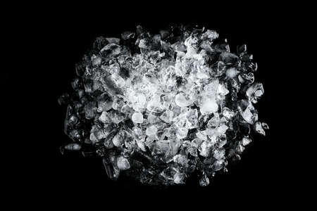 Heap of crushed ice on black table, top viewの写真素材