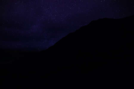 Beautiful view of starry sky over mountains at nightの写真素材