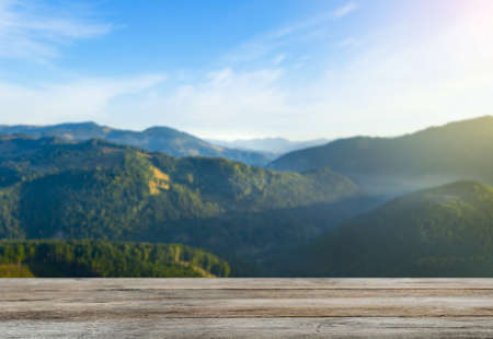 Empty wooden surface and beautiful view of mountain landscape on sunny day. Space for designの写真素材