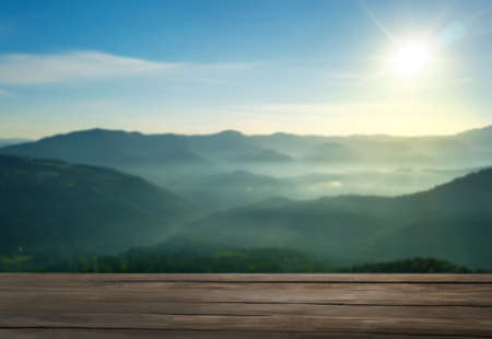 Empty wooden surface and beautiful view of mountain landscape on sunny day. Space for designの写真素材