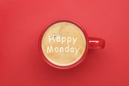 Happy Monday. Cup of aromatic coffee on red background, top viewの写真素材