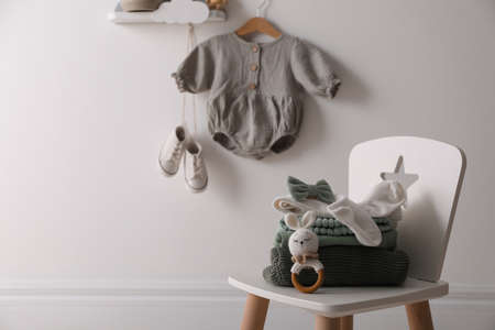 Cute children's clothes and shoes in room. Space for textの写真素材
