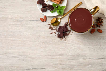 Flat lay composition with yummy hot chocolate on white wooden table, space for textの写真素材