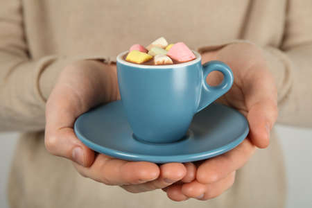 Woman holding cup of delicious hot chocolate with marshmallows, closeupの写真素材