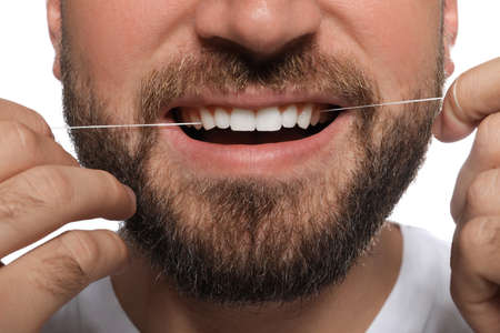 Man flossing his teeth on white background, closeup. Dental careの写真素材