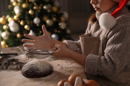 Little child making Christmas cookies at table indoors, closeupの写真素材