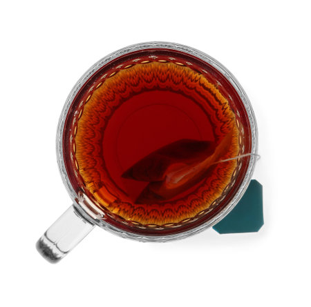 Tea bag in glass cup of hot water isolated on white, top viewの写真素材
