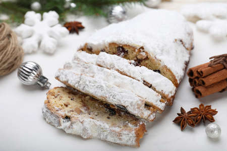 Traditional Christmas Stollen with icing sugar on white board, closeupの写真素材