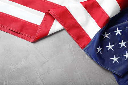 National flag of America on light gray table, top view. Space for text