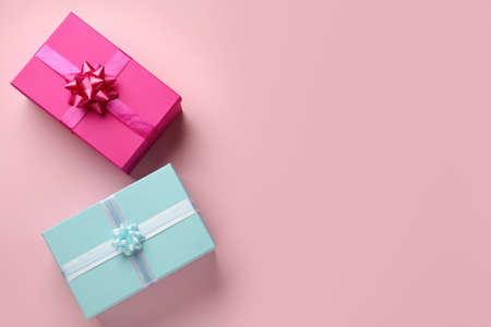 Bright gift boxes on pink background, flat lay. Space for textの写真素材
