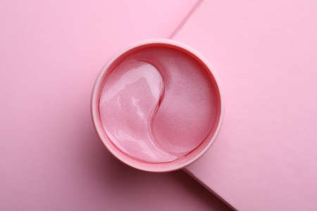 Package of under eye patches on pink background, top view. Cosmetic productの写真素材