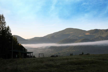 Amazing view of beautiful foggy mountains in morningの写真素材